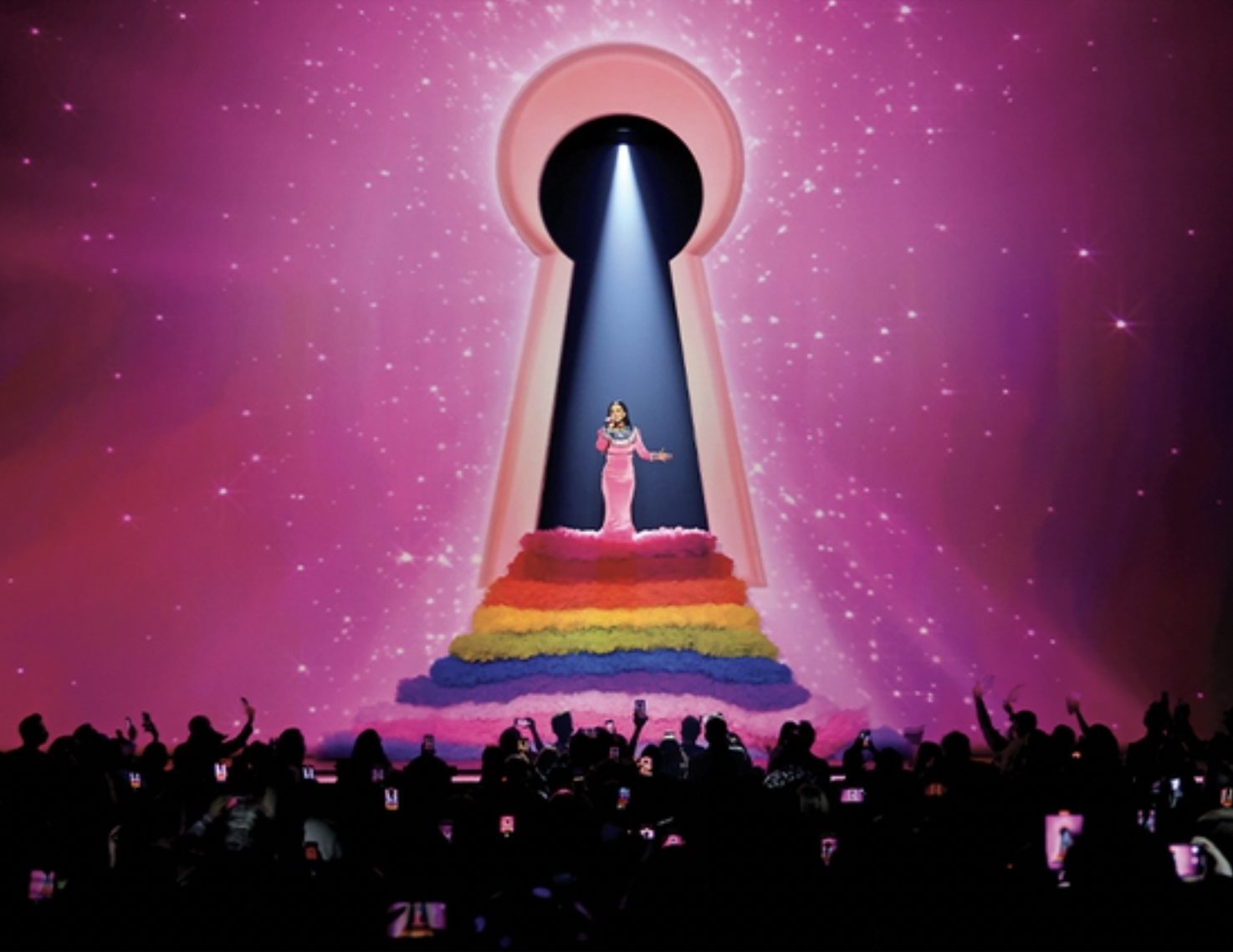 Katy Perry sings inside a giant glowing keyhole on a starry pink screen