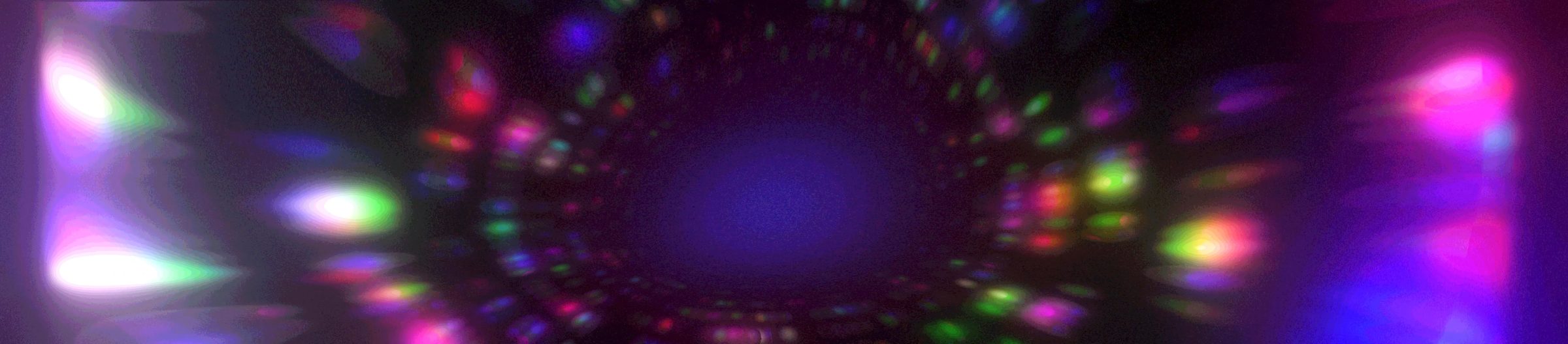 A tunnel of colored lights rushing toward a dark center